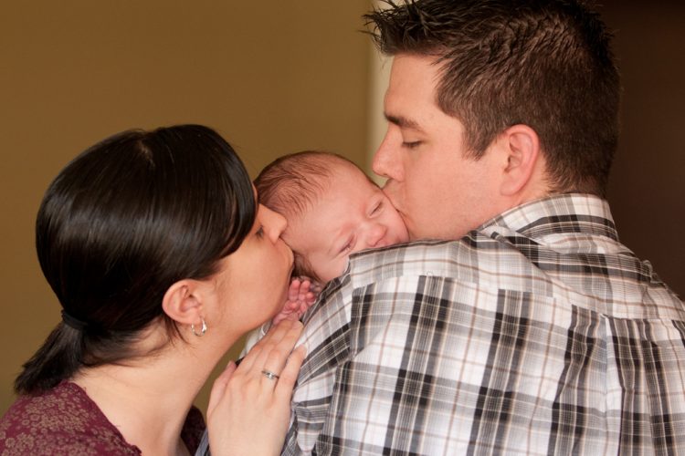 new-parents-kissing-newborn-baby1.jpg